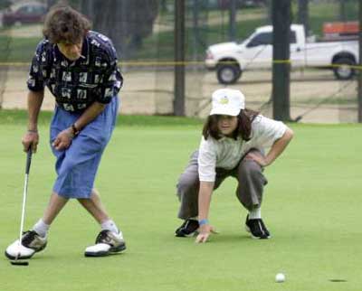 Ed Van Halen and Wolfgang Van Halen, lining up a putt